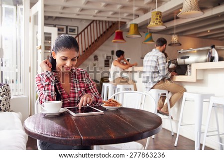 Young woman using laptop in a cafe