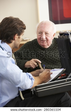 Doctor visiting senior man at home