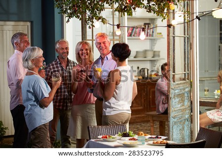 Group Of Friends Enjoying Outdoor Evening Drinks Party
