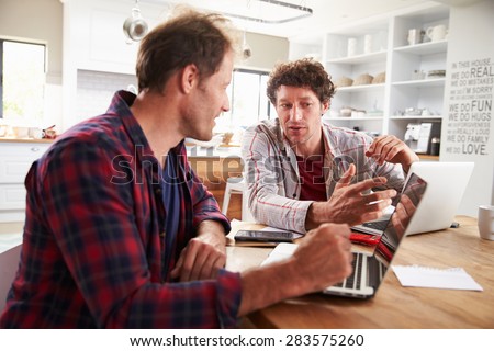 Small business partners using computers at home
