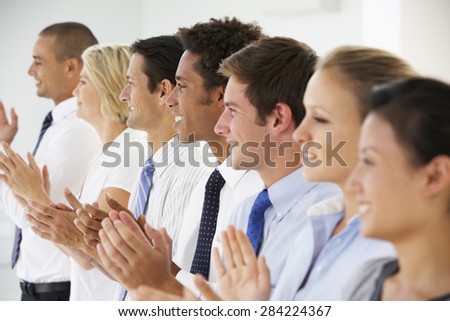 Line Of Happy And Positive Business People Applauding
