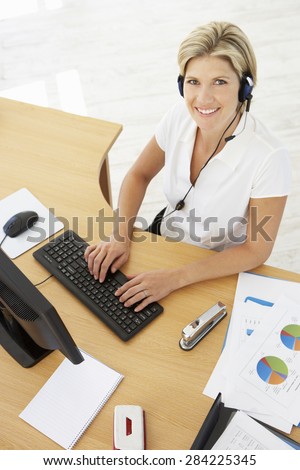 Overhead View Of Service Agent Talking To Customer In Call Centre