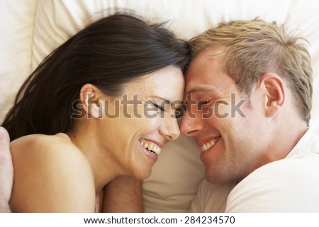Couple Relaxing In Bed