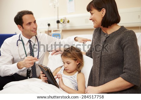 Doctor Talking To Mother And Daughter In Hospital Bed
