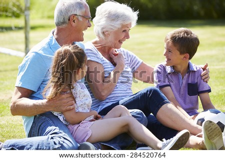 Grandparents And Grandchildren Playing Football In Garden