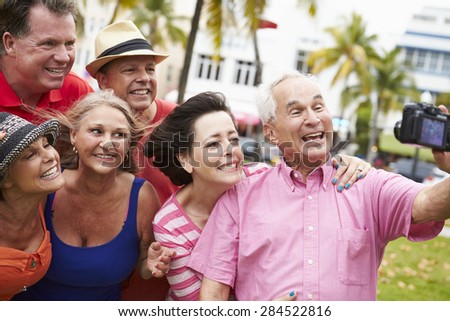 Group Of Senior Friends Taking Selfie In Park