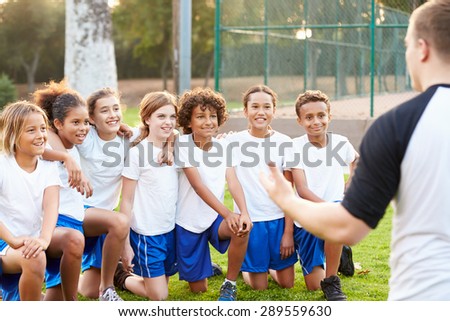 Youth Football Team Training With Coach