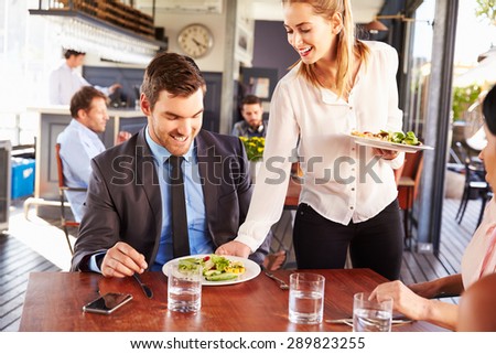 Business man being served food in a restaurant