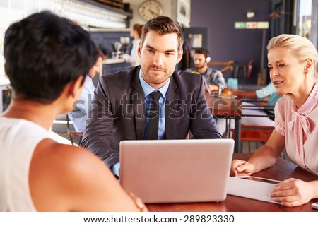 Group of business people with laptop meeting in coffee shop