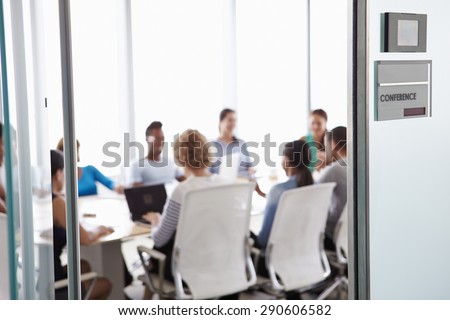 View Through Door Of Conference Room To Business Meeting