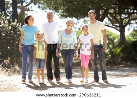 Three Generation Family On Summer Countryside Walk Together