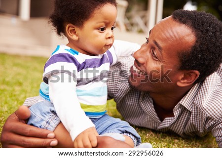 Father bonding with his toddler son in a garden