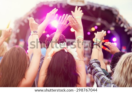 Audience with hands in the air at a music festival