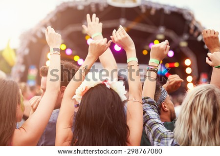 Audience with hands in the air at a music festival 商業照片 © 