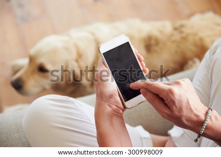 Close Up Of Woman Using Smartphone At Home