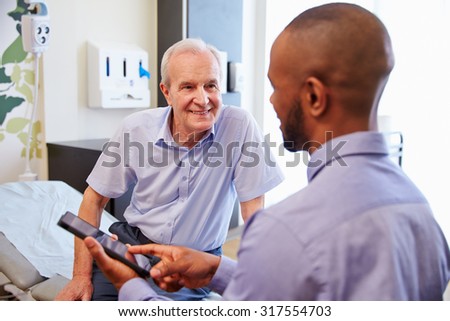 Senior Patient And Doctor Have Consultation In Hospital Room