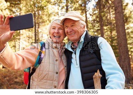 Similar – Image, Stock Photo Senior couple enjoying autumn colors together