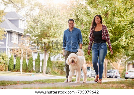 Similar – Image, Stock Photo Couple is walking along the ocean