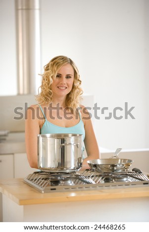 smiling woman in front of a kitchen