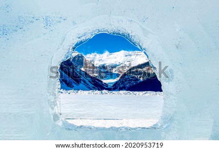 Christmas window to the winter mountains. Winter ice window. Icy window to winter mountains in snow