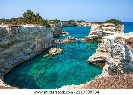 Melendugno,province of Lecce, Puglia, Italy. August 2021. The stacks of Sant'Andrea are a point of naturalistic attraction: the amazing landscape suggests a tropical destination. People taking a bath. Photo stock © 