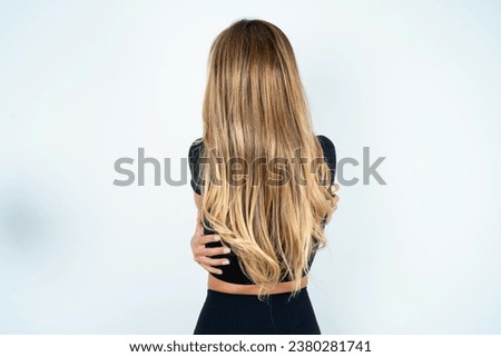 Similar – Image, Stock Photo Rear view blonde woman walking in the evening on field, low sun