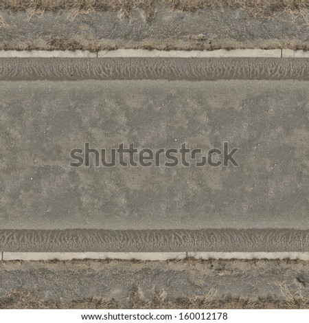 Seamless road texture of grey asphalt with wet, sandy surface.