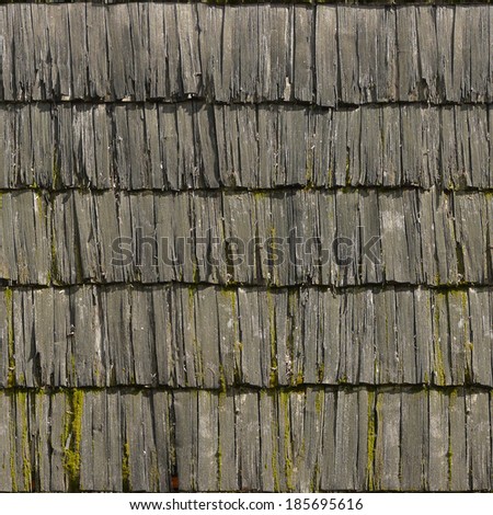 Roof made of rotting, grey planks with splintering edges and moss spots.