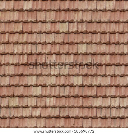 Roof made of stone shingles in light pink tone with patterns on surface.