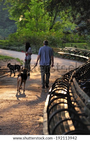 New York City, NY, USA - August 26 2009: People walking with dogs in the morning, Central Park, Manhattan