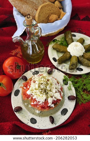 Greek salad with goat cheese, crushed tomato and olives, traditional Greek food