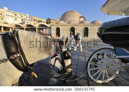 Crete, Greece, - August. 29. 2008: Horse carriage and mosc at Chania, town on Crete, Greece. Old town and harbor is surrounded by the old Venetian fort that started to be built in 1538