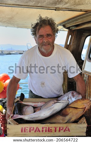 Crete, Greece, - August. 30. 2008: local fisherman with the catch of the day at the bay of Heraklion, the capital of the island of Crete, Greece