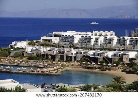 swimming pool and open air balcony at the modern luxury hotel with Aegean Sea as background, Crete, Greece