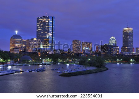 Boston city skyline at dusk with reflection of the skyscrapers over Charles River