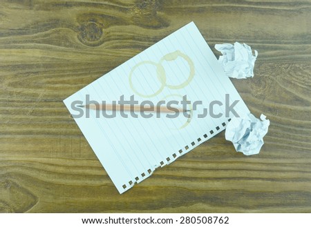 Empty paper, crumpled paper and pencil on wooden table