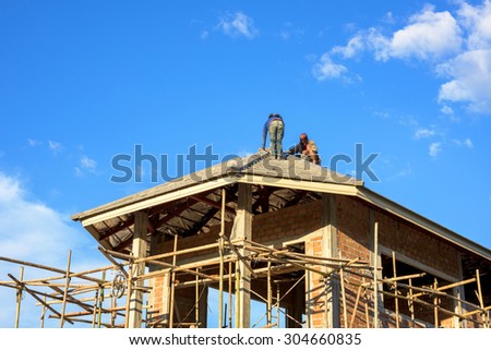 labor working in construction site for roof