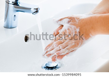 Similar – Image, Stock Photo Woman washing hands with hand sanitizer alcohol antibacterial to prevent germs, bacteria and avoid coronavirus infections