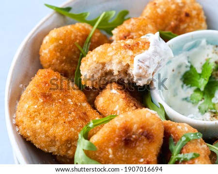 Close-up Vegetarian Nuggets, Vegan Dipping Sauce and rocket leaves on a light background, space for text, selective focus. Healthy and delicious vegan food. Diet, Protein Vegetarian Meals concept.