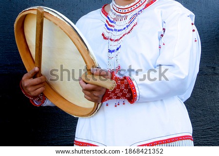 A national costume from East Greenland and the traditional Greenlandic drum.