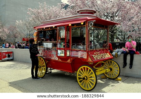 Washington, DC - April 11, 2014:  Popcorn Vendor\'s classic wagon standing in front of the NASA Museum with its grove of flowering cherry trees