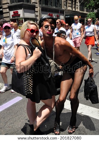 NYC - June 29, 2014:  Young man and woman dressed in black strike a pose at the 2014 Gay Pride Parade on Fifth Avenue