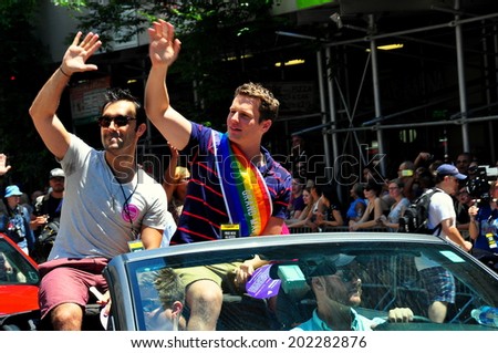 NYC - June 29, 2014:  Grand Marshal Broadway actor and TV star Jonathan Groff (in blue shirt) riding in a convertible at the 2014 Gay Pride Parade on Fifth Avenue