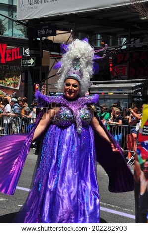 NYC - June 29, 2014:  Man in opulent drag costume marching in the 2014 Gay Pride Parade on Fifth Avenue