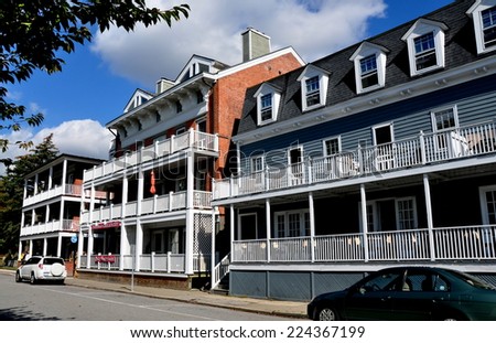 Cold Spring, NY - October 17, 2014:  The 19th century Hudson House River Inn (right) with two other handsome West Street buildings with their distinctive white wooden porches