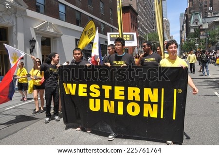NYC - June 2, 2012:   Western Union workers marching behind their banner at the 2012 Philippines Independence Day Parade on Madison Avenue