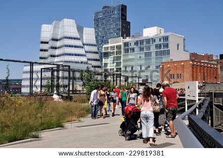 New York City - August 27, 2010:  Crowds strolling along the popular High Line Park built atop a 1930\'s freight rail line on Manhattan\'s West Side near Frank Gehry\'s IAC Building on the left