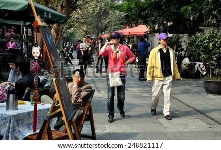 Chengdu, China - November 3, 2009:  People walking along elegant Kuanxiangzi Alley lined with fine shops, pubs, and restaurants in Old Town