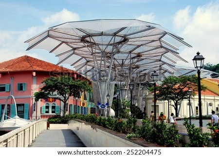 Singapore - December 13, 2007:  Read Bridge spanning the Singapore River  with futuristic umbrella canopies leads to trendy Clarke Quay