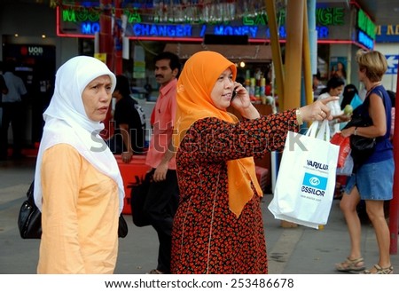 Singapore - December 17, 2007: Two Muslim women wearing traditional clothing and head scarves walking along Serangoon Road in Little India